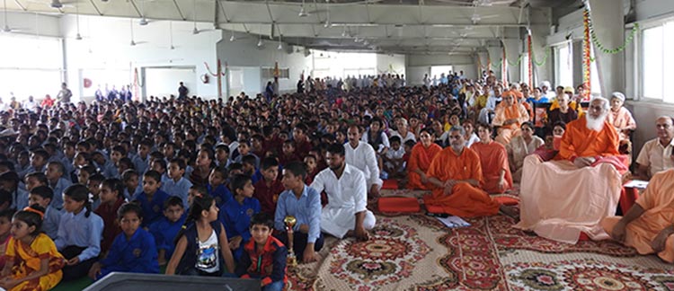 Swamiji and devotees watching cultural programme at the school